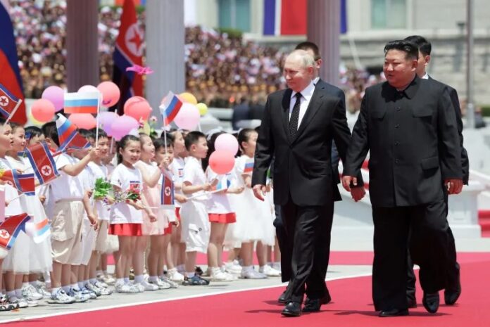 North Korean leader Kim Jong Un welcoming Russia's President Vladimir Putin | SOURCE: Sputnik via AFP